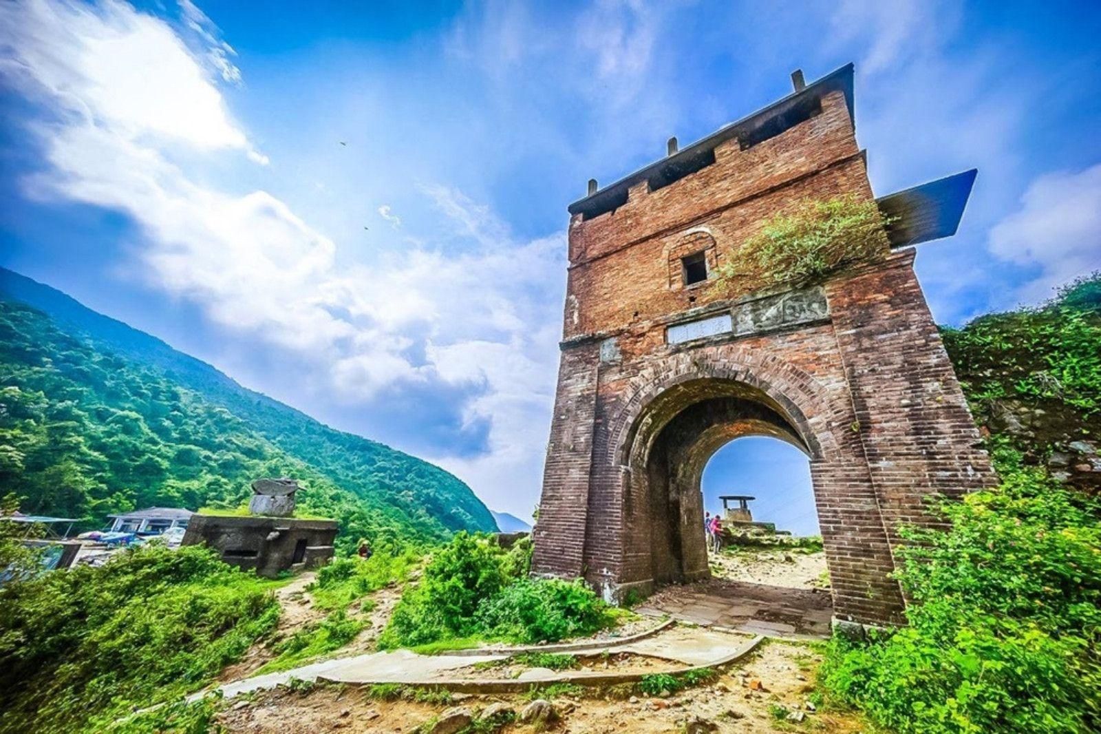 Mountain scenery and historic gateway at Hai Van Pass summit in Vietnam